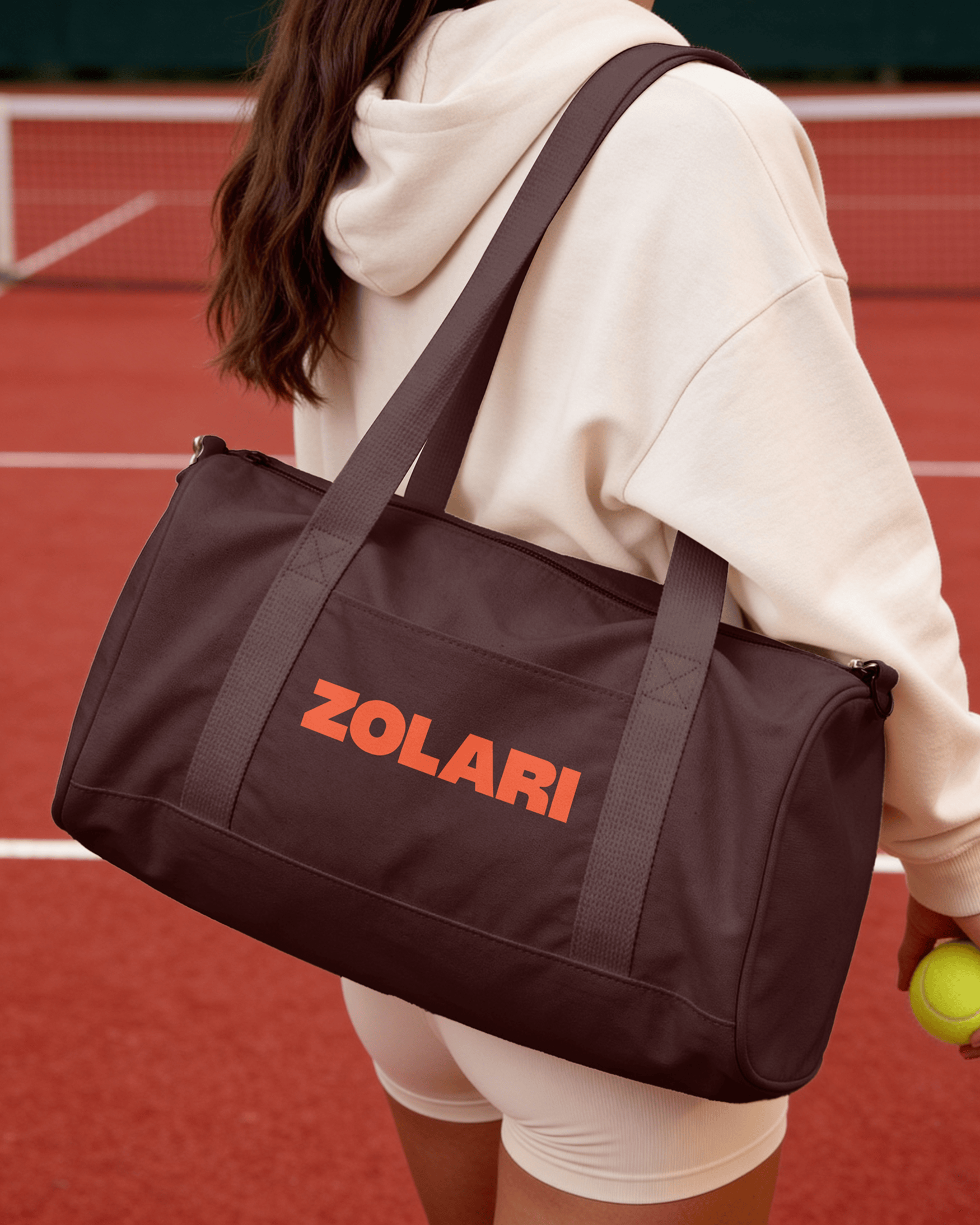 Brown Zolari duffle bag on a tennis court